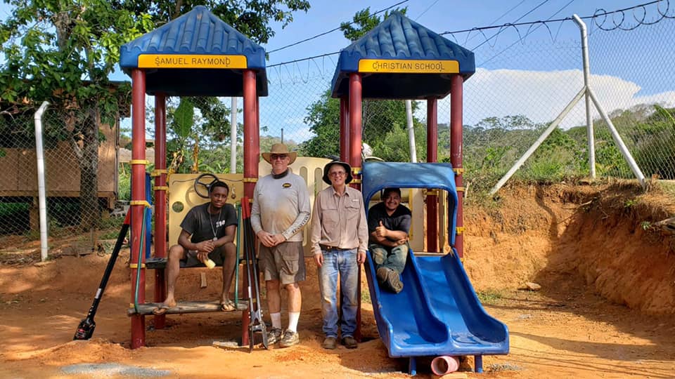 Community members helping build a playground